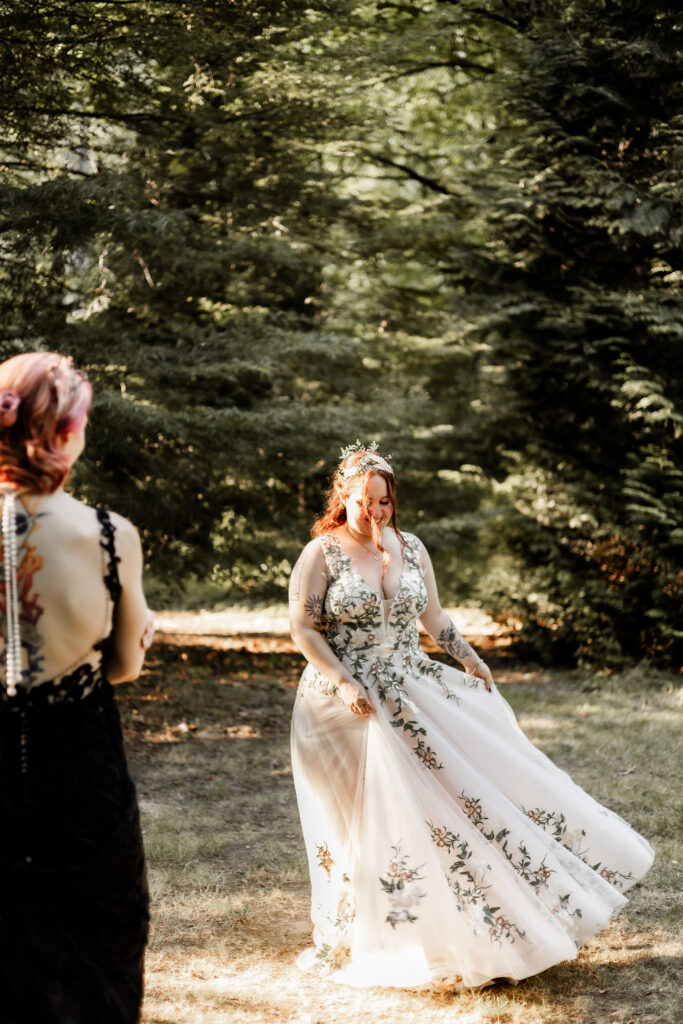 One bride watches the other twirl at this forest elopement in Langley