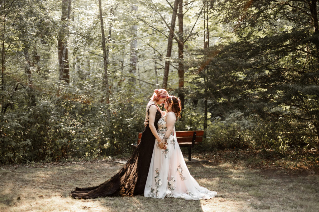 Brides touch their foreheads together at this forest elopement in Langley