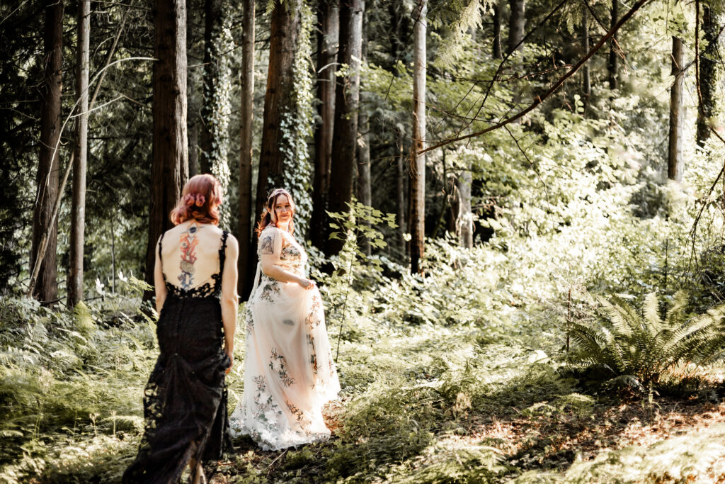 Brides walk through the trees at this forest elopement in Langley