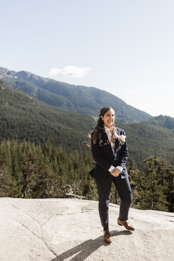 Melissa smiles at Kat walking down the aisle at this Sea to Sky Gondola wedding