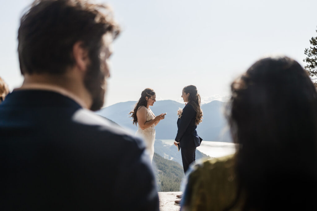 The couples friends watch them recite their vows at this Sea to Sky Gondola wedding