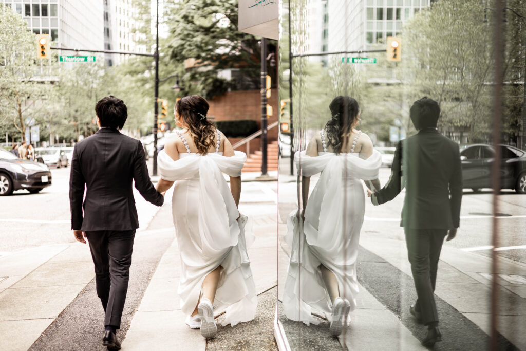 The bride and groom walk down the street at their downtown Vancouver Marriott Pinnacle wedding