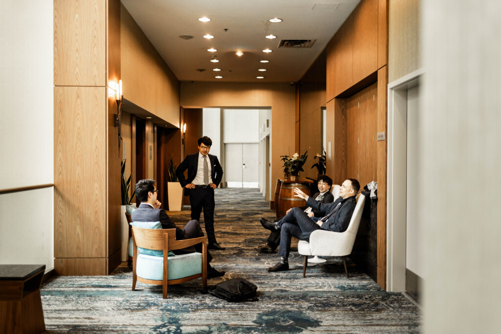 Groomsmen chatting in the hallway at the Marriott Pinnacle wedding