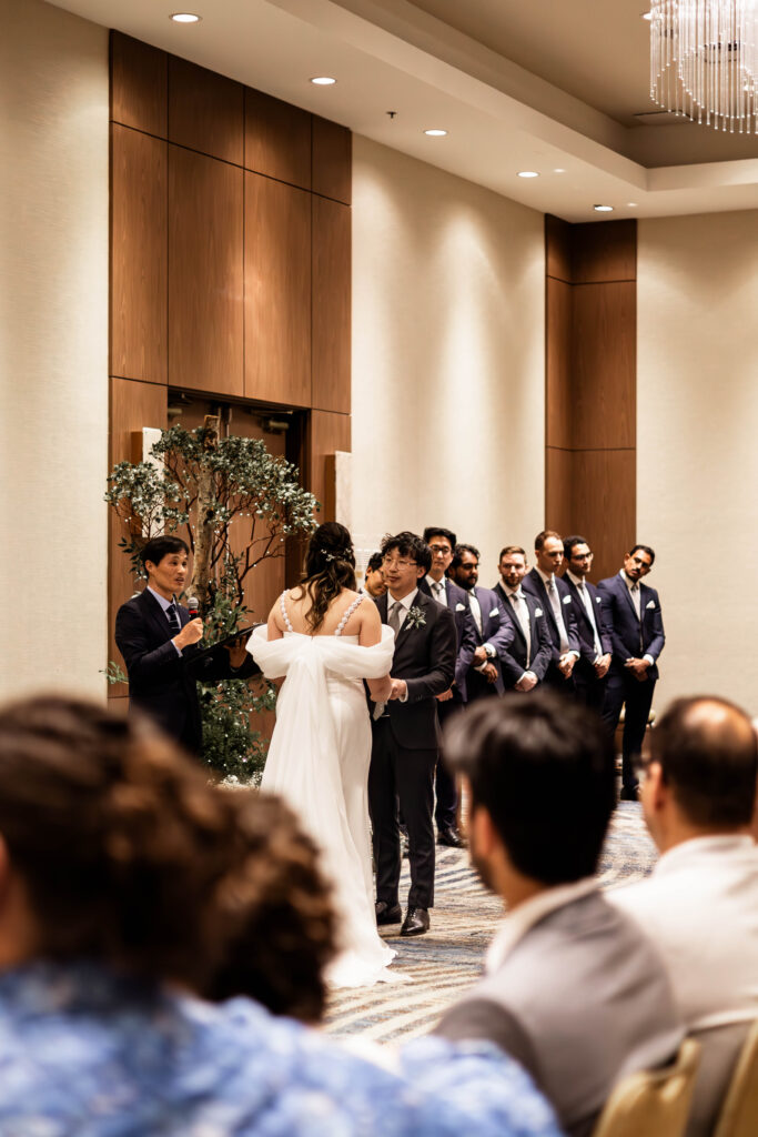 The bride and groom stand at the altar at their downtown Vancouver Marriott Pinnacle wedding