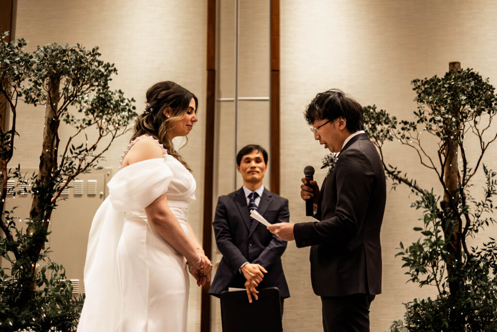 The groom reads his vows to his bride at this downtown Vancouver Marriott Pinnacle wedding