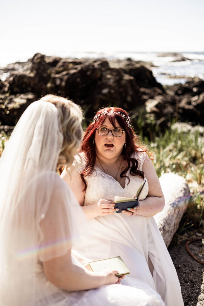 Two brides share their private vows with one another on the beach at their Black Rock Oceanfront Resort wedding.