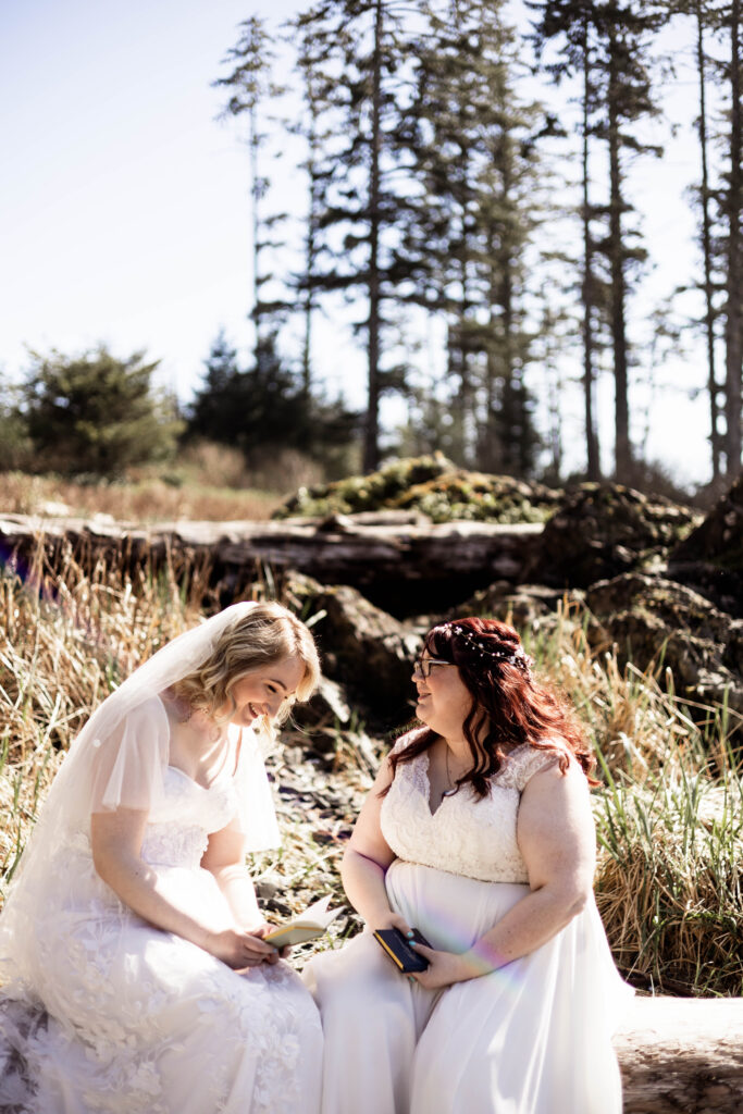 The brides share a laugh as they read their personal vows to one another at Big Beach during their Black Rock Oceanfront Resort wedding.