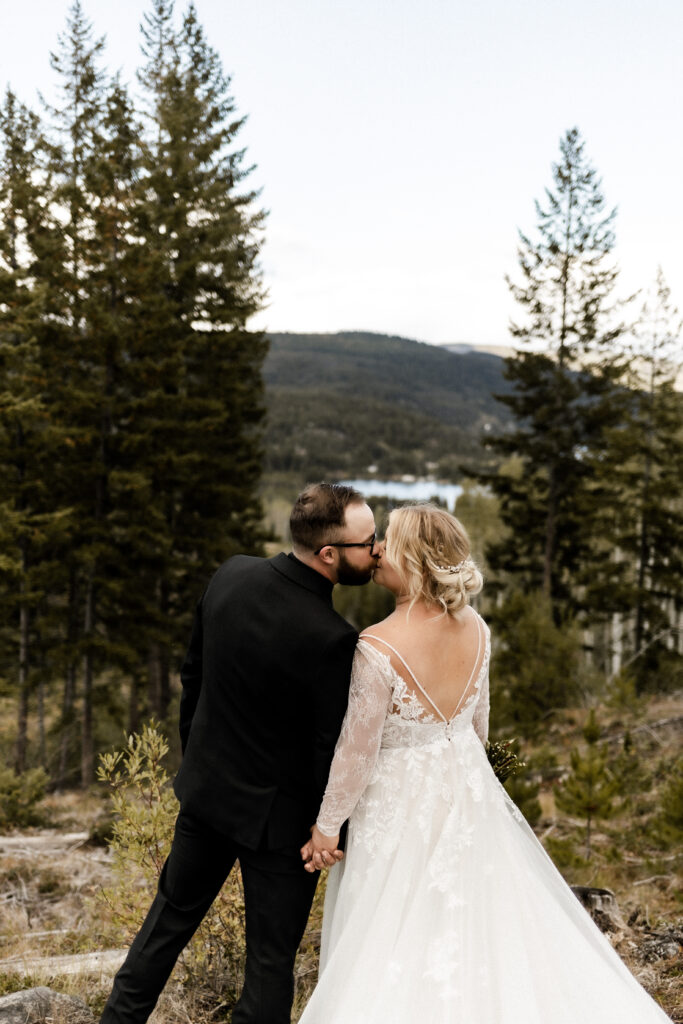 Bride and groom share a kiss in front of the view at this cabin elopement