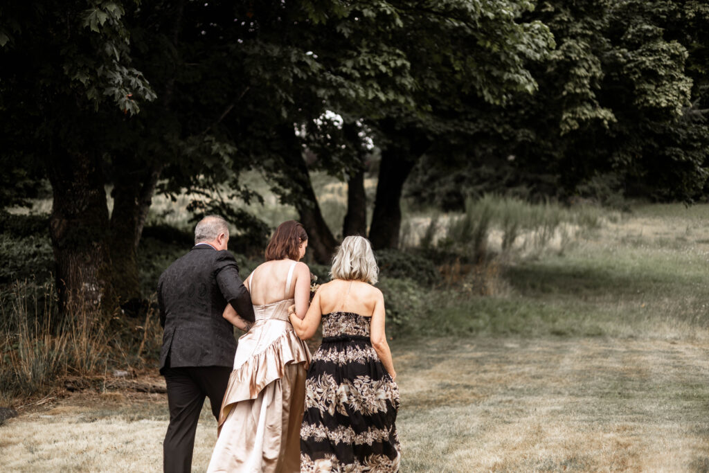 Bride is walked down the aisle by her parents at this Church and State Winery wedding