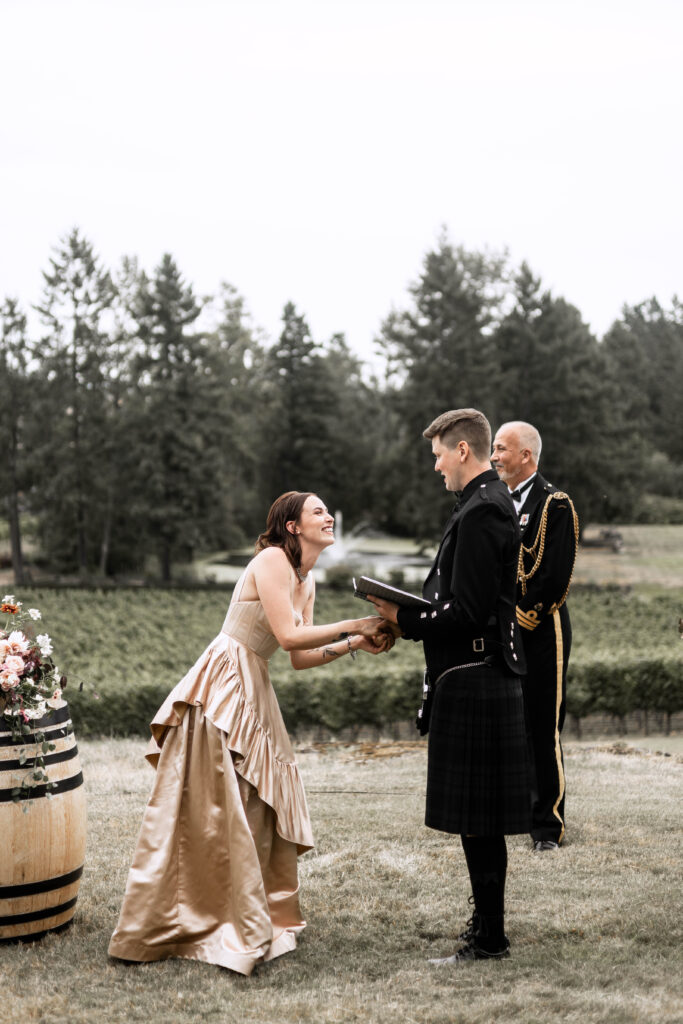 The bride laughs as her groom reads his vows at this Church and State Winery wedding