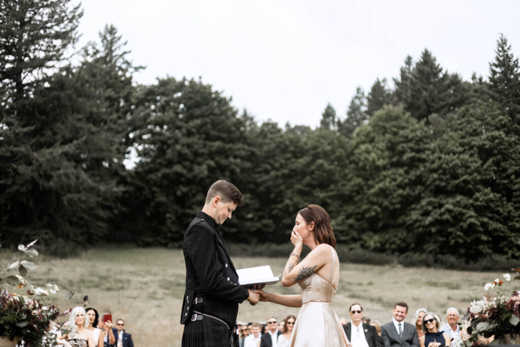 Bride stifles a cry as the groom reads his vows during the ceremony at this Church and State Winery wedding