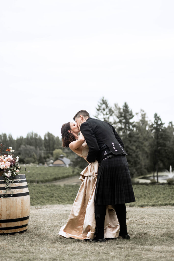 Bride and groom share a first kiss at this Church and State Winery wedding