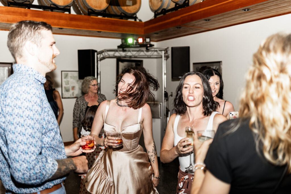 The bride dances with guests on the dance floor at this Church and State Winery wedding