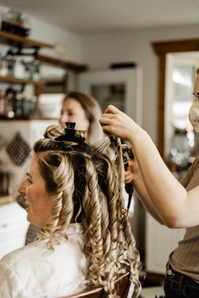 The bride gets her hair done at this Canim Lake wedding