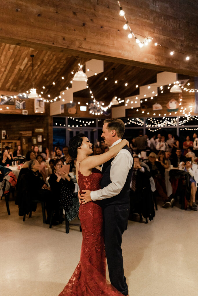 The bride and groom have their first dance in front of all their guests at their Gibsons Island summer camp wedding at Camp Elphinstone