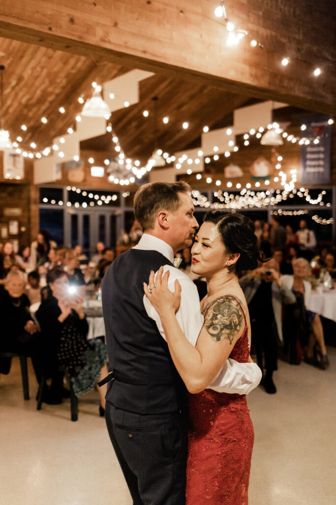 The bride and groom have their first dance in front of all their guests at their Gibsons Island summer camp wedding at Camp Elphinstone