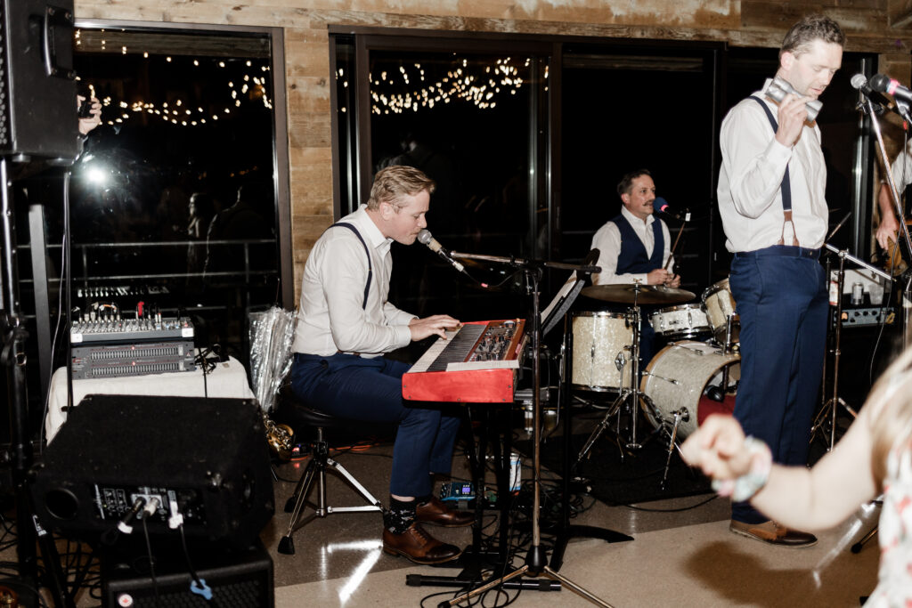 A live band plays at this Gibsons Island summer camp wedding at Camp Elphinstone