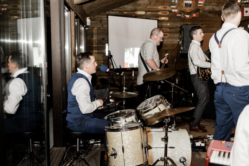 A live band plays at this Gibsons Island summer camp wedding at Camp Elphinstone