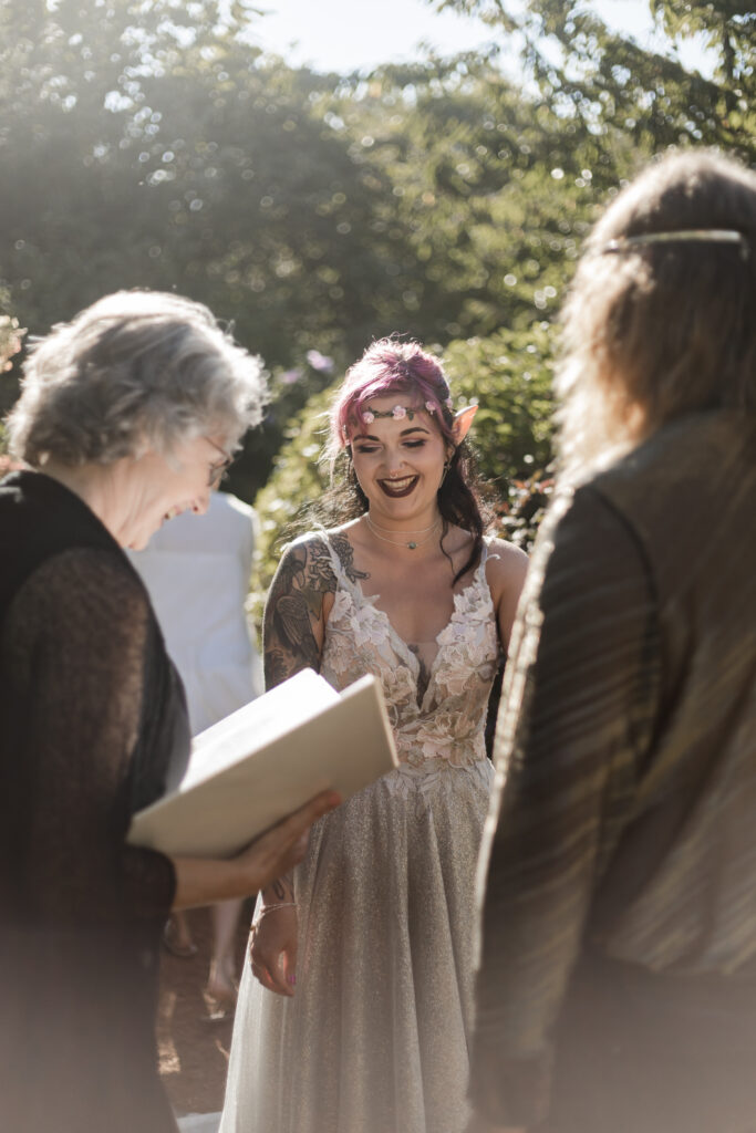 The bride laughs during vows at the altar at this Vancouver Island costume wedding