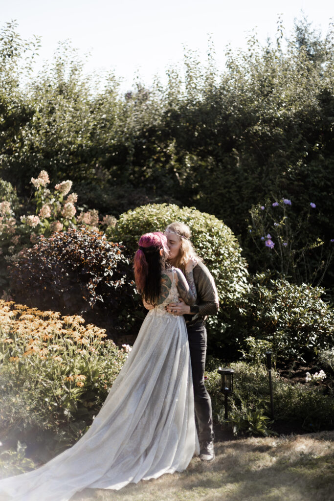 The bride and groom share a first kiss at this Vancouver Island costume wedding