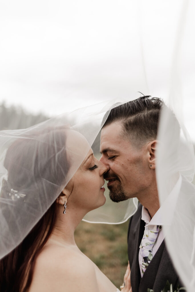 bride and groom go in for a kiss at this Cobble Hill Winery wedding