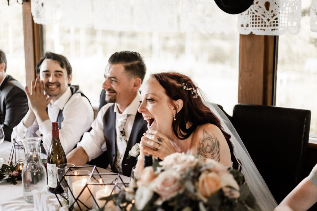 bride and groom laugh during speeches at this Cobble Hill Winery wedding