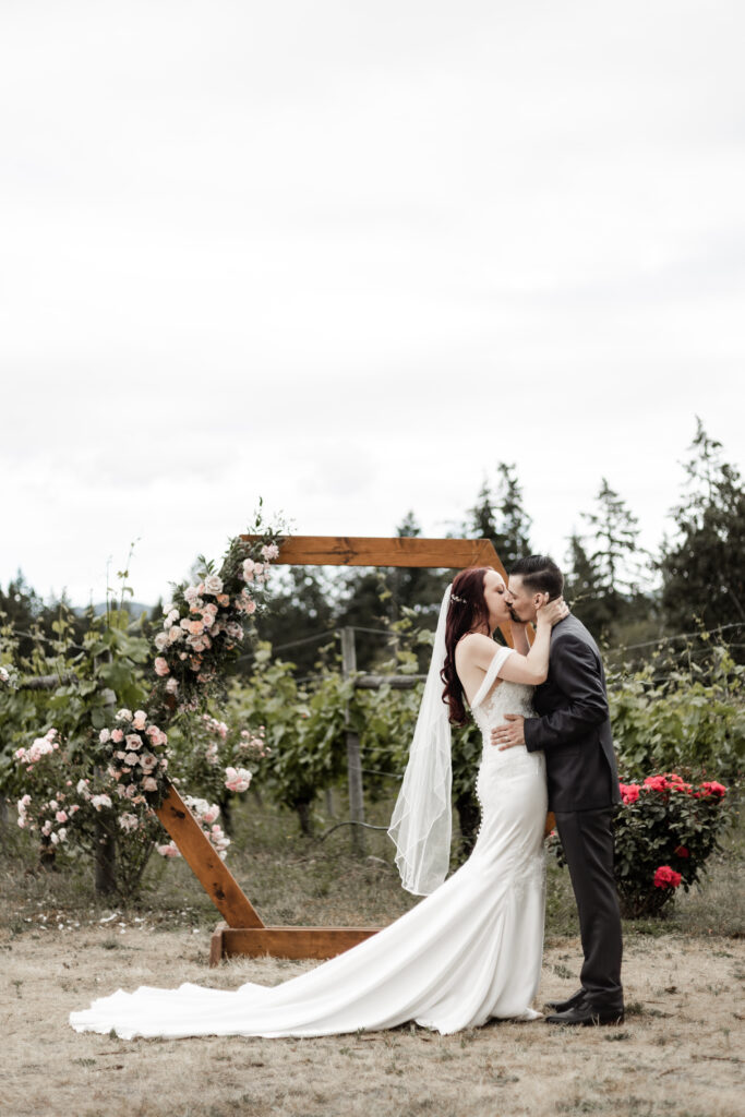 the bride and groom have their first kiss at this Cobble Hill Winery wedding