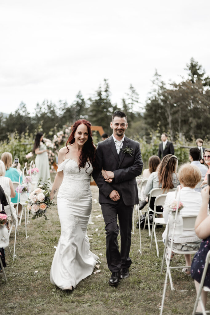 bride and groom walk back down the aisle at this Cobble Hill Winery wedding