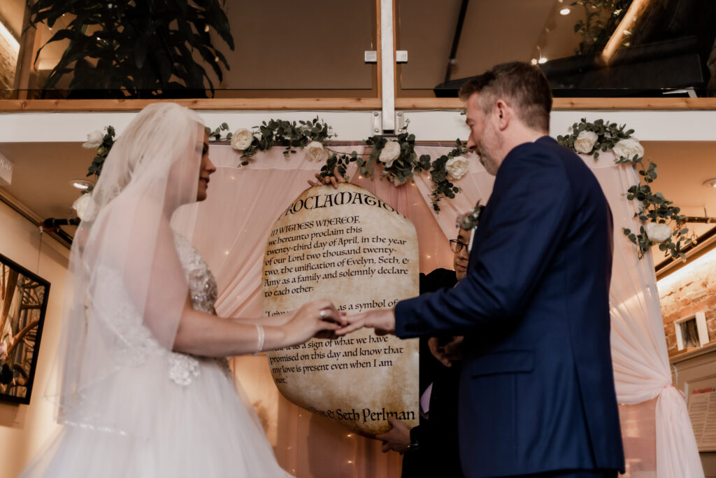 bride and groom exchange rings at this downtown Victoria wedding