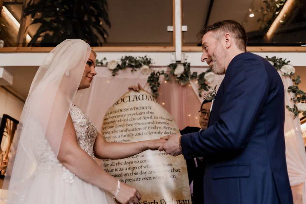 bride and groom exchange rings at this downtown Victoria wedding