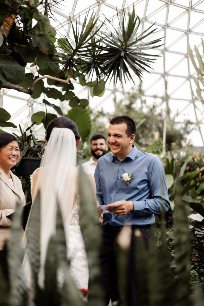 The groom laughs as he reads his vows at this Bloedel Conservatory wedding 