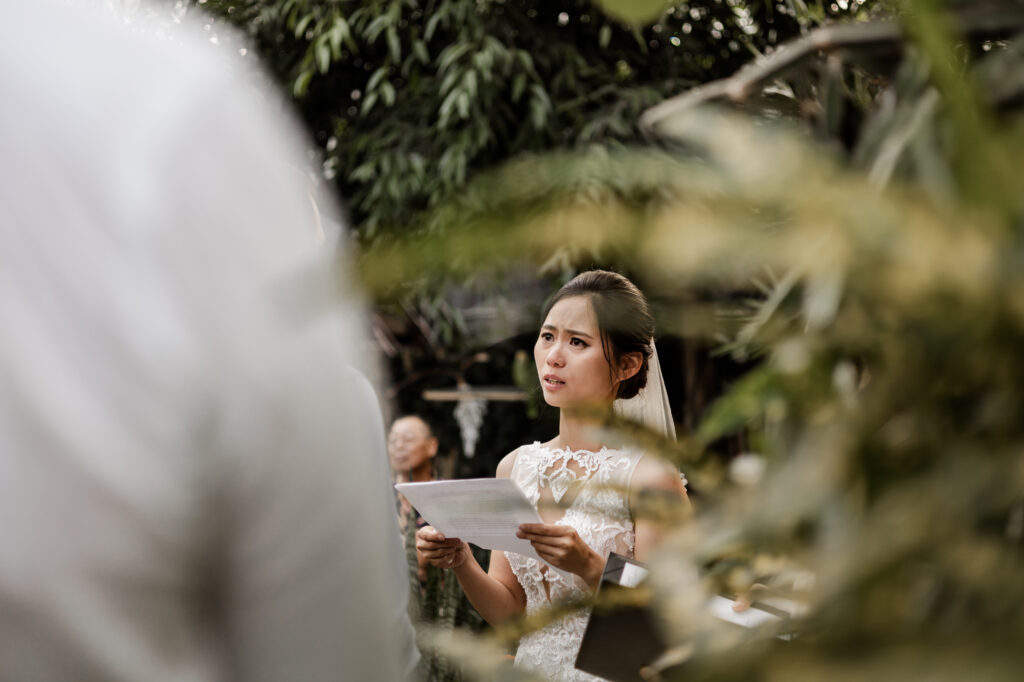 The bride tears up as she reads her vows at this Bloedel Conservatory wedding 