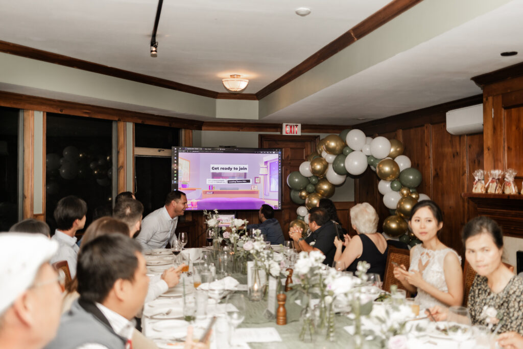 The wedding guests play a game of kahoot in Seasons at the Park at this Bloedel Conservatory wedding 