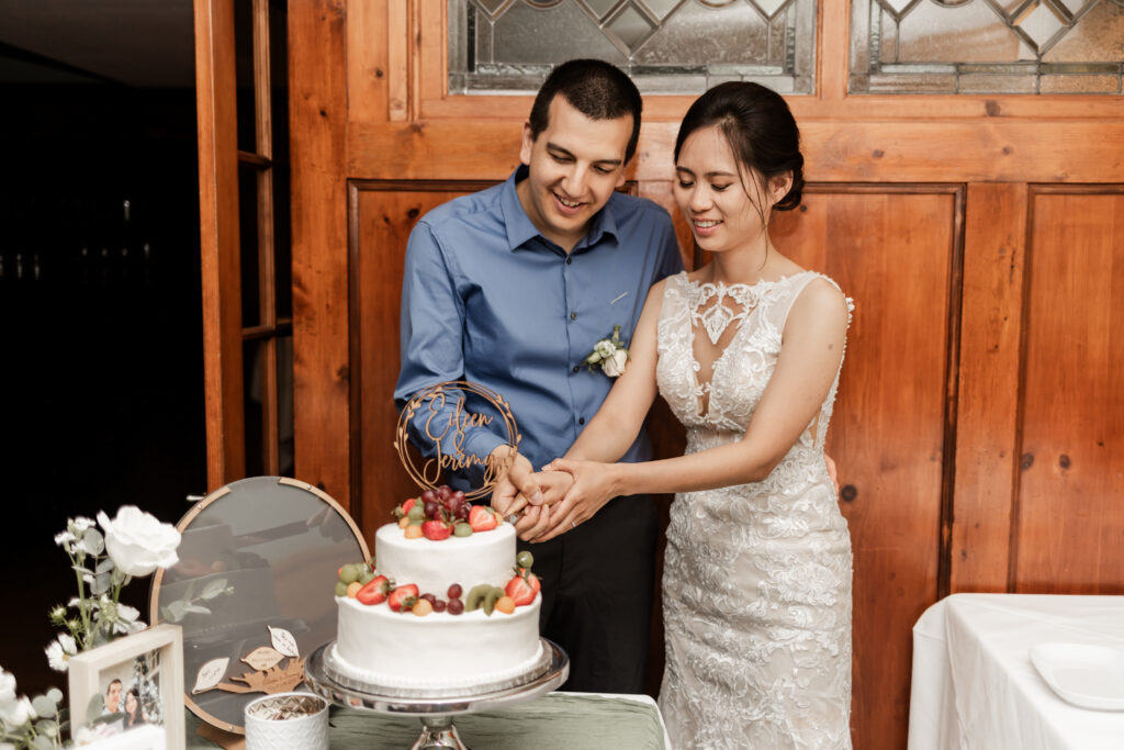 The bride and groom cut their cake at this Bloedel Conservatory wedding 