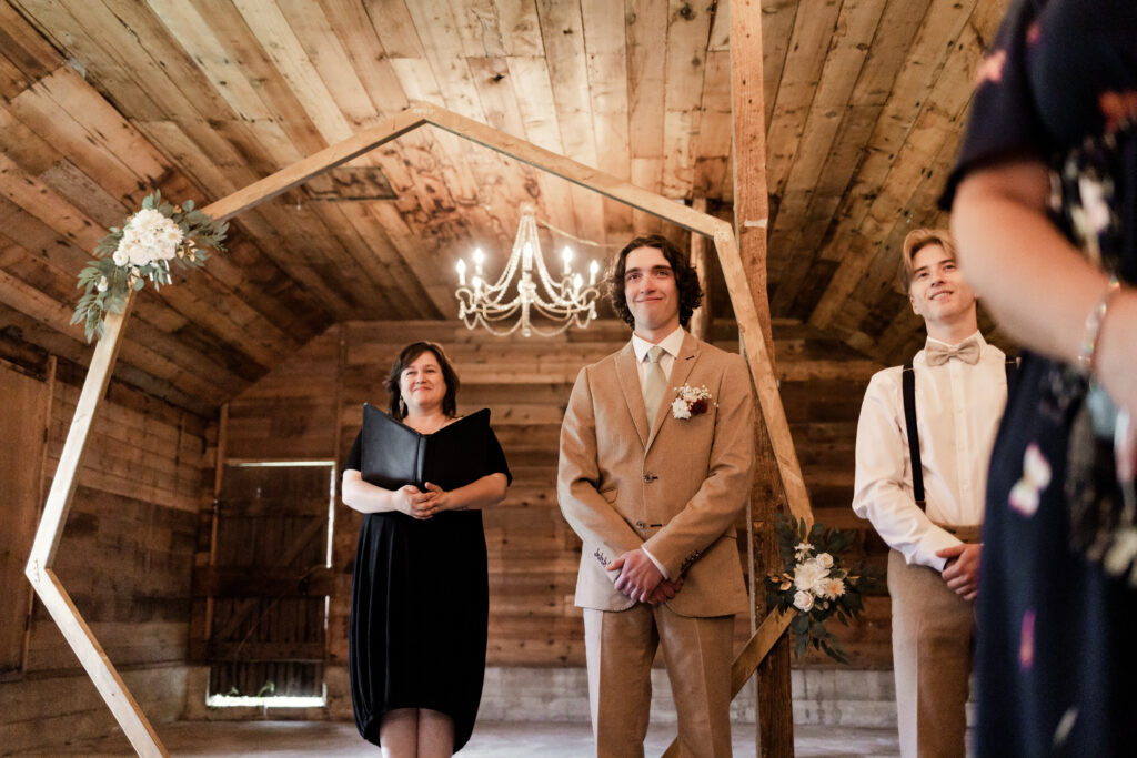 The groom holds back tears as his bride walks towards him down the aisle at this Estate 248 wedding in Langley, British Columbia