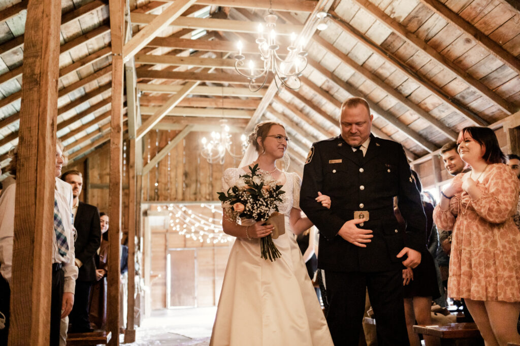 The bride is walked down the aisle by her father at this Estate 248 wedding in Langley, British Columbia