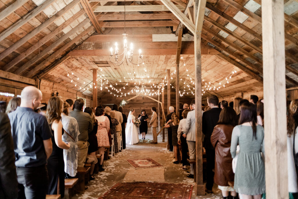 A far away shot of the bride and groom standing at the altar at this Estate 248 wedding in Langley, British Columbia