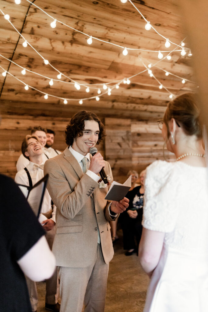 The groom smiles at the bride as he says his vows during this Estate 248 wedding in Langley, British Columbia