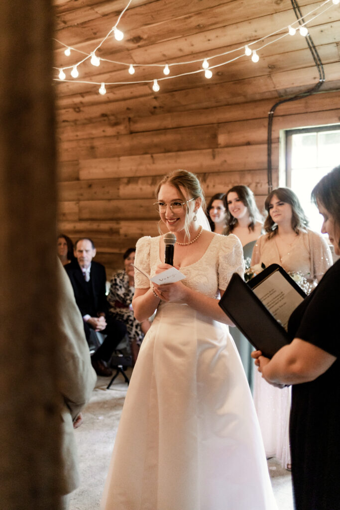 The bride smiles at the groom as she says her vows at this Estate 248 wedding in Langley, British Columbia