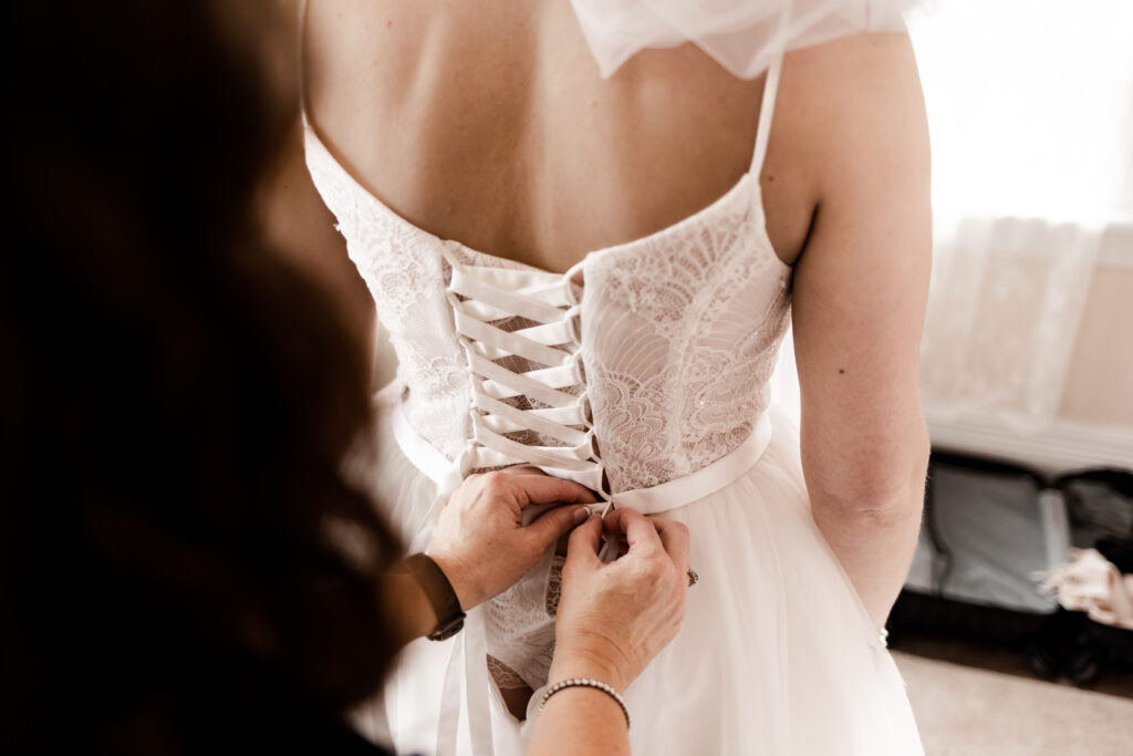 The bride gets her dress laced up at this Estate 248 wedding in Langley, British Columbia