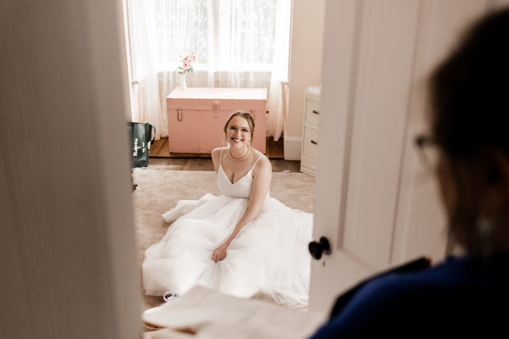 The bride relaxes for a moment on the floor at this Estate 248 wedding in Langley, British Columbia