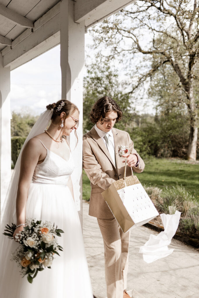 The groom opens a gift at this Estate 248 wedding in Langley, British Columbia