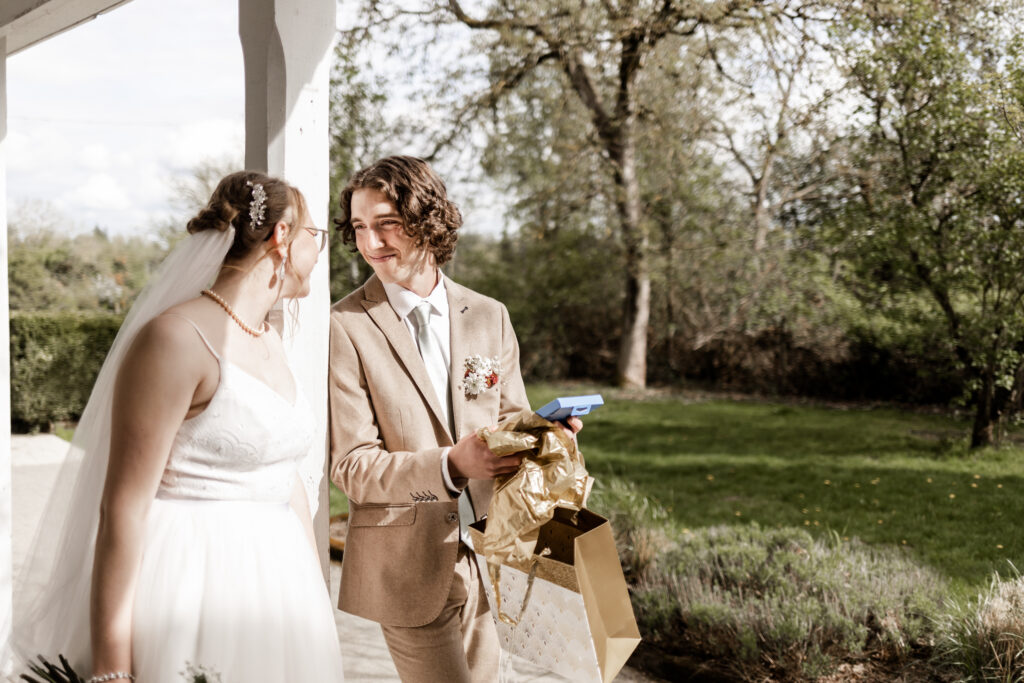 The groom opens a gift at this Estate 248 wedding in Langley, British Columbia