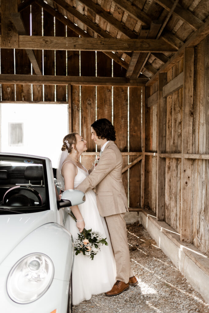 bride and groom lean against a baby blue volkswagon at their Estate 248 wedding in Langley, British Columbia