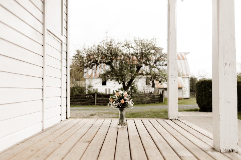 Flowers standing in a vase outside the bridal suite at an Estate 248 wedding in Langley, British Columbia