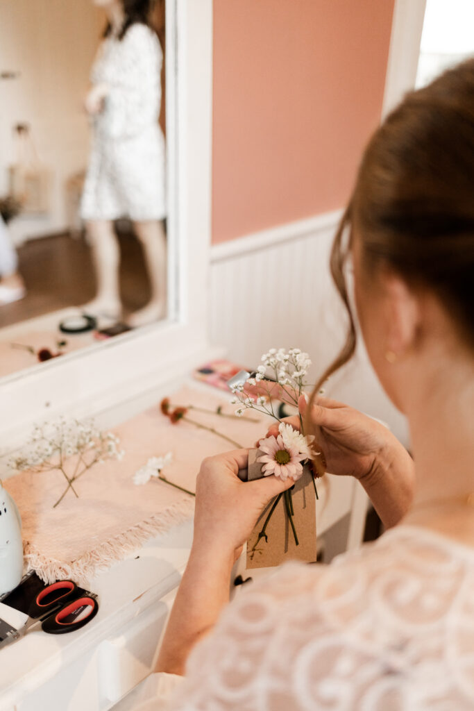 An up close of the bride putting together boutonnieres at this Estate 248 wedding in Langley, British Columbia