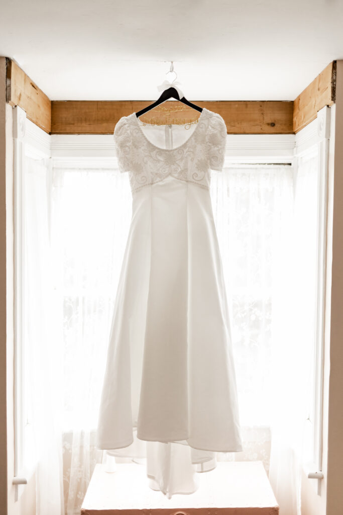 The wedding dress hanging in the window at this Estate 248 wedding in Langley, British Columbia