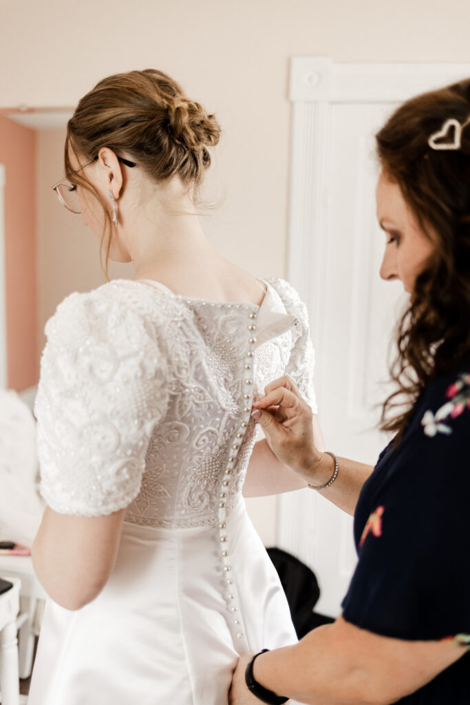 The bride getting her dress done up at this Estate 248 wedding in Langley, British Columbia