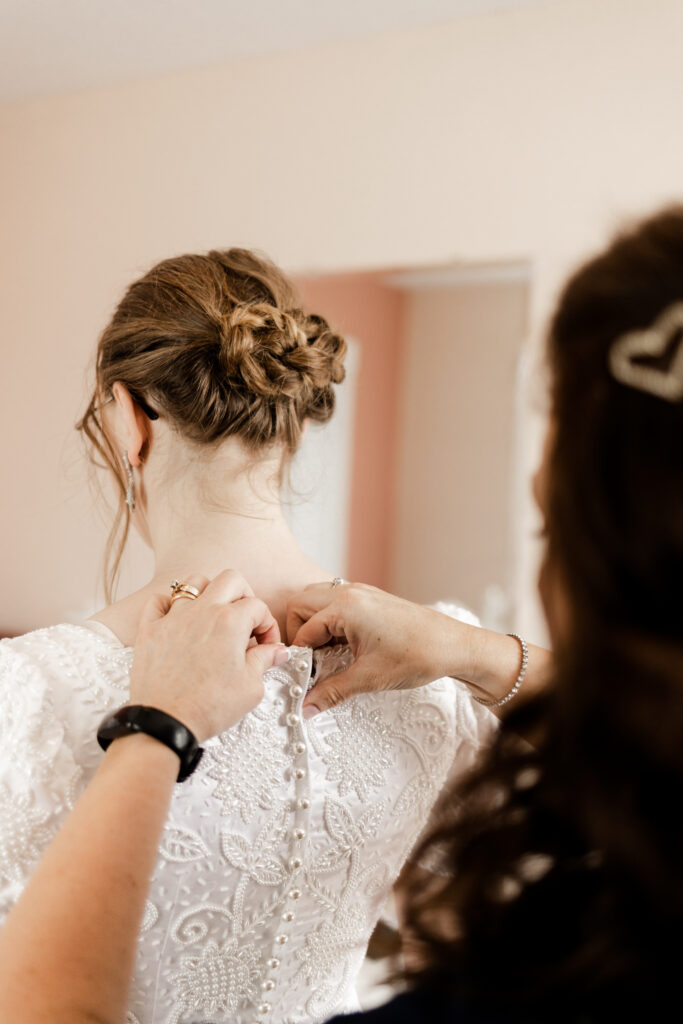 The bride getting her dress done up at this Estate 248 wedding in Langley, British Columbia