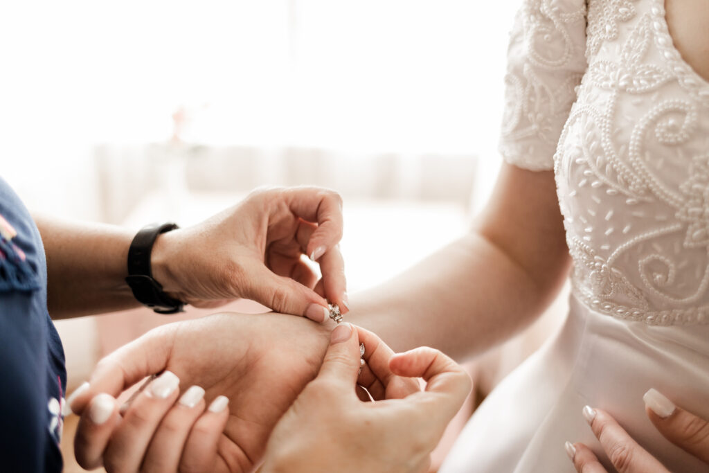 An up close of a bracelet being done up on the bride's wrist at this Estate 248 wedding in Langley, British Columbia